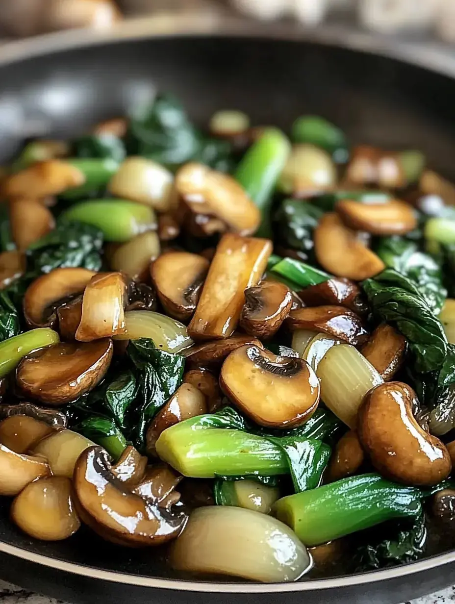 A close-up of a stir-fried dish featuring sliced mushrooms, green onions, and leafy greens in a dark sauce.