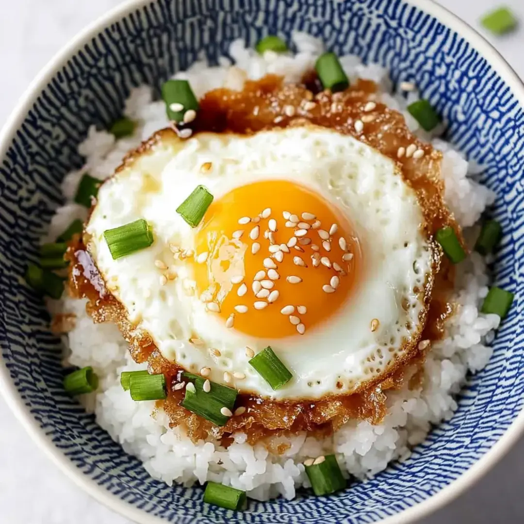 A bowl of rice with an egg on top.