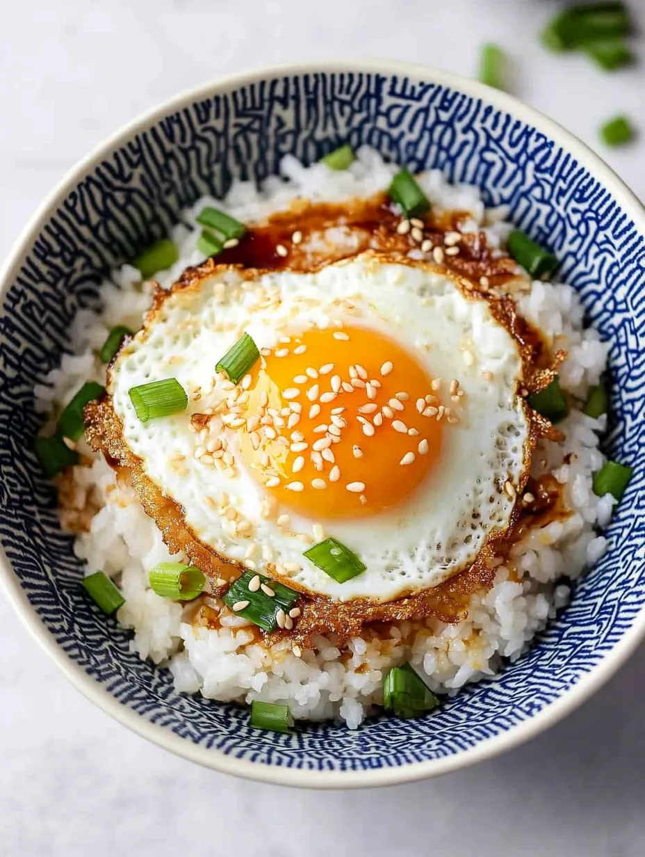 A bowl of rice with an egg on top.