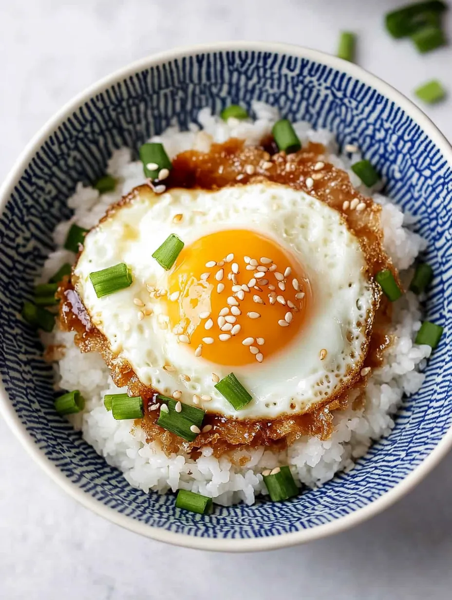 A bowl of rice with an egg on top.