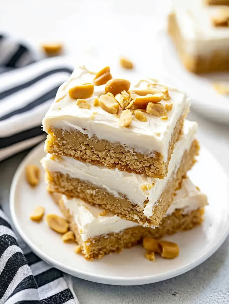 A stack of cake slices with peanut butter and nuts on top.