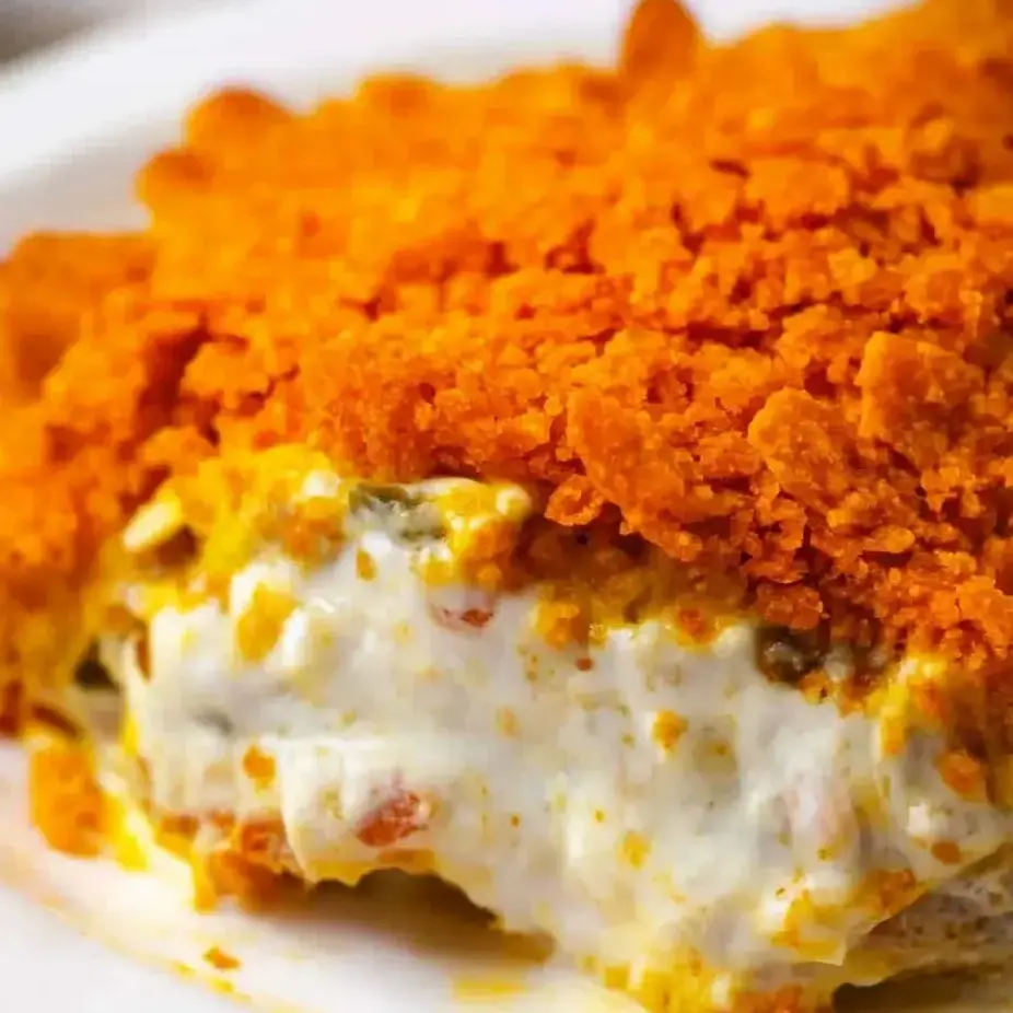 A piece of food with a white plate underneath.