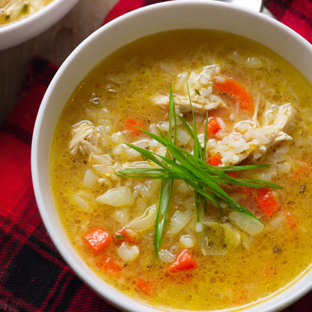 A bowl of soup with a green garnish.