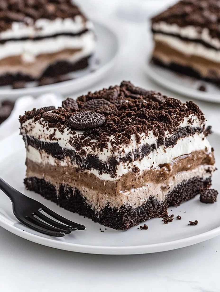 A slice of chocolate cake with Oreo cookies on top.