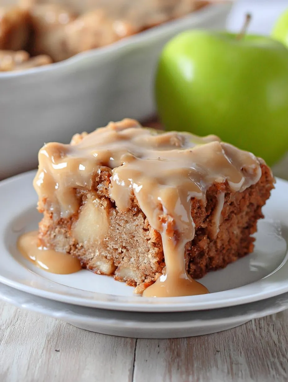 A piece of cake with caramel sauce on a white plate.