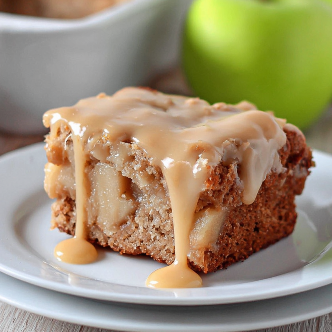 A piece of cake with caramel sauce drizzled on top.