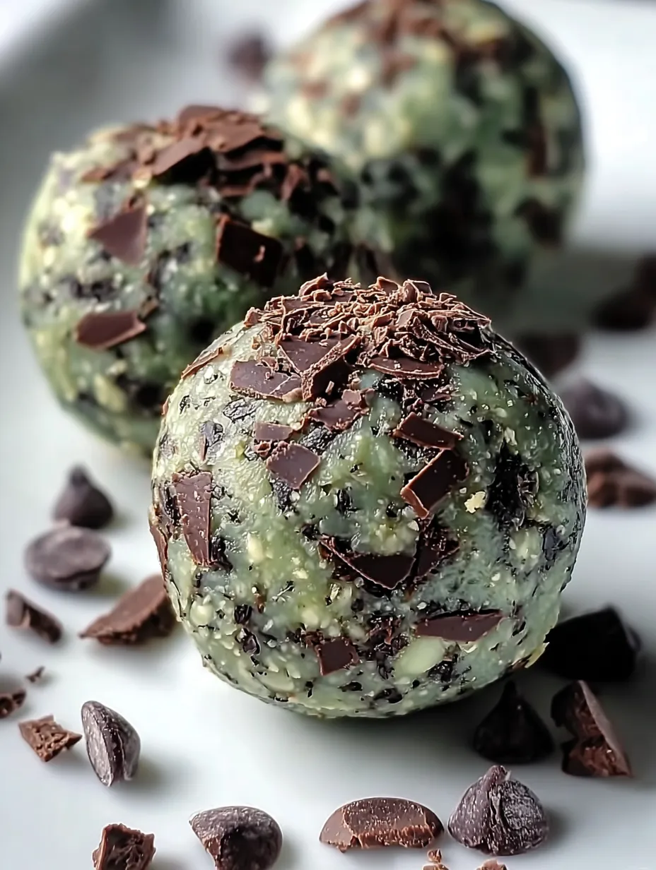 Two chocolate covered balls of something green.