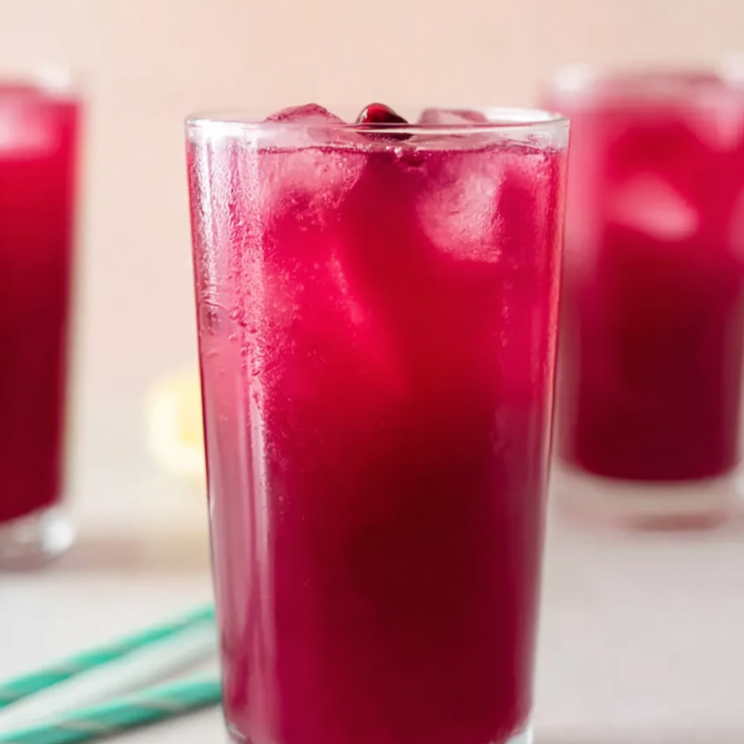 A glass of red juice with ice.