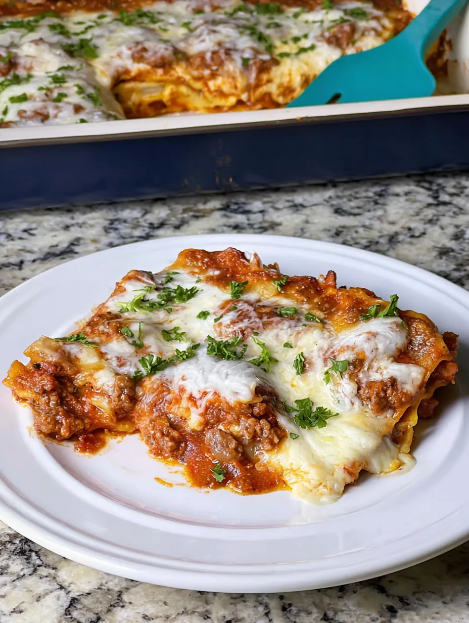A plate of lasagna with cheese and herbs.