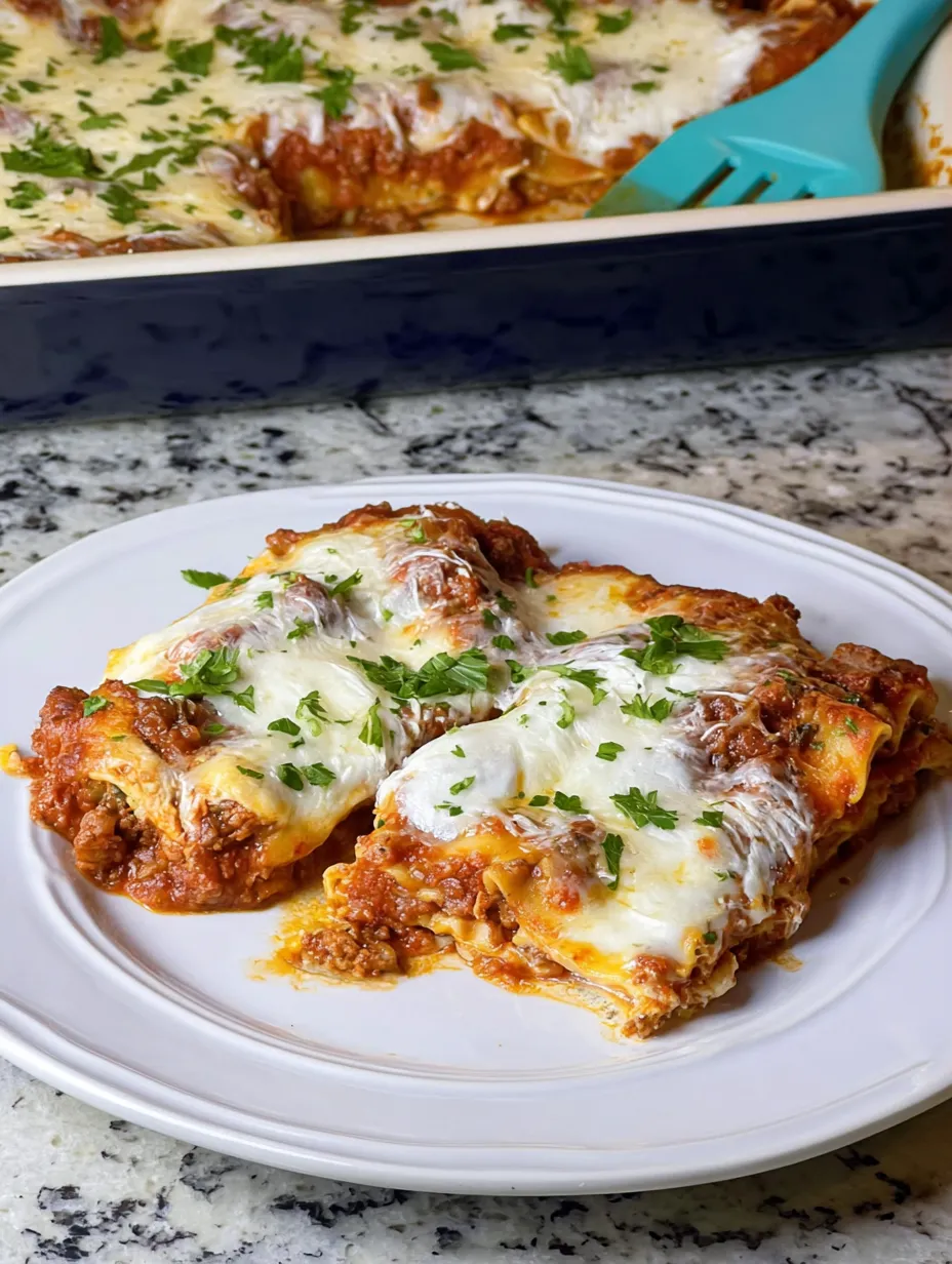 A plate of lasagna with cheese and herbs.