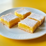 A plate of desserts on a yellow table.