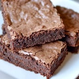 A white plate with a delicious chocolate brownie.