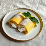 A plate with two crepes on it.