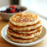 A stack of pancakes on a plate.