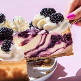 A slice of blueberry cheesecake is being eaten.