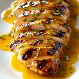 Chicken with sauce on a plate.