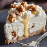 A slice of cheesecake with caramel drizzle.
