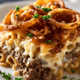 A plate of food with onion rings and meat.