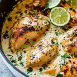 Chicken served in a bowl with lime and cilantro on top.
