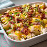 A white bowl piled with cheese and bacon.