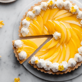 A slice of yellow cake with white frosting.