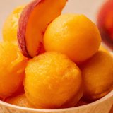 A bowl of peaches and plums.