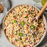 A bowl of pasta with jalapenos and corn.