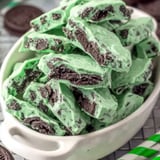 A bowl of chocolate and green candy.