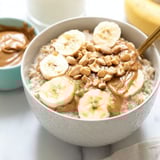 A bowl of oatmeal with bananas and peanut butter.