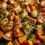 A pan of chicken and carrots.